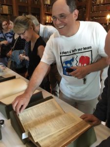 BSF Artistic Director Tom Delise is very happy to touch a First Folio for the first time at Evergreen Museum & Library.
