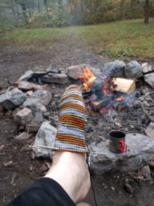 knitting a sock in the woods
